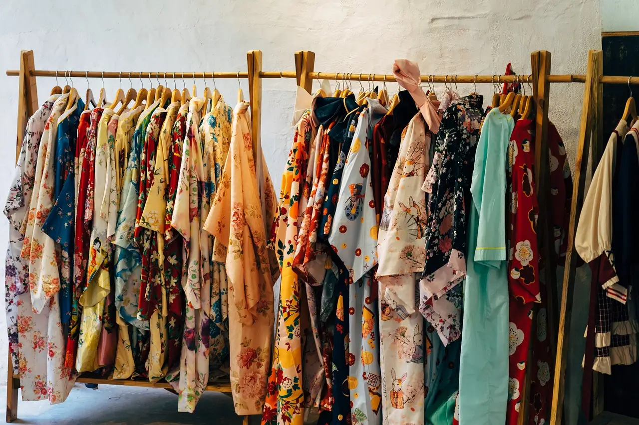 A rack of bright patterned shirts and dresses
