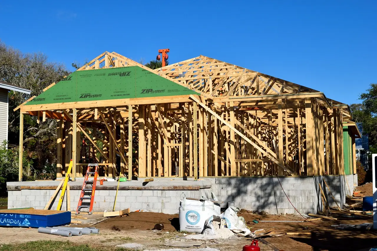 A new house in framing, with a ladder against the wall
