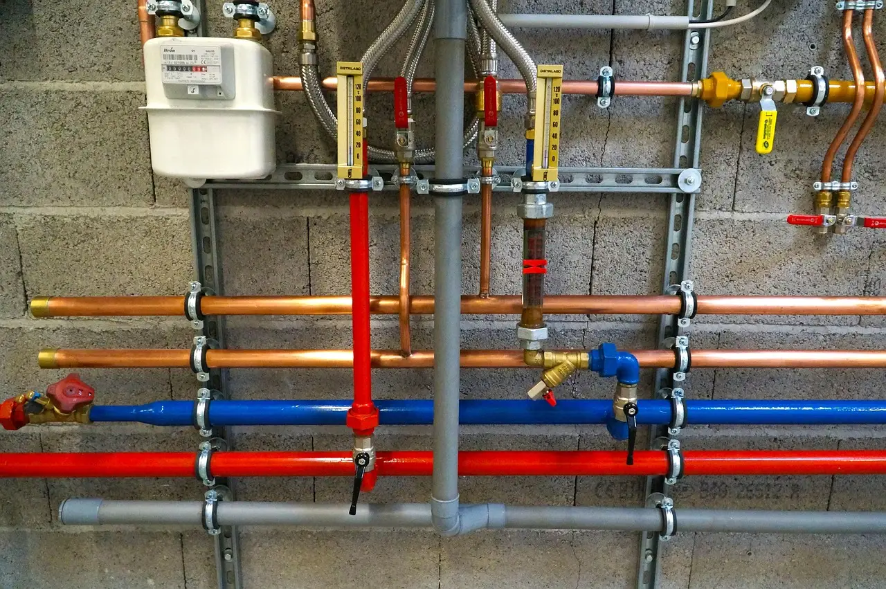 A wall of new water lines and shutoff valves, freshly plumbed